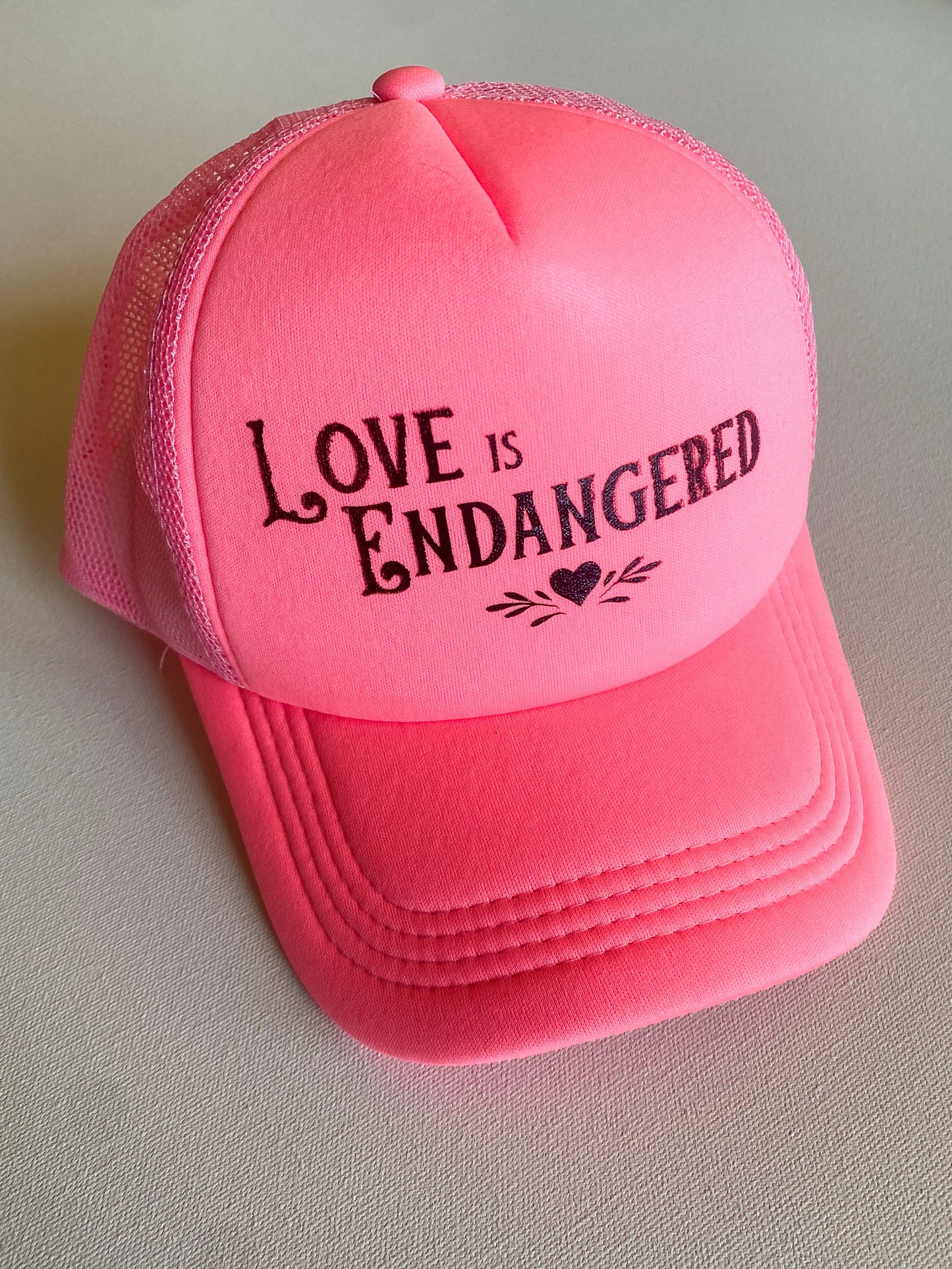 Love is Endangered Trucker Hat
